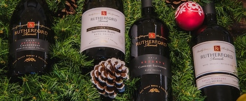 wine bottles among pine and holiday decor