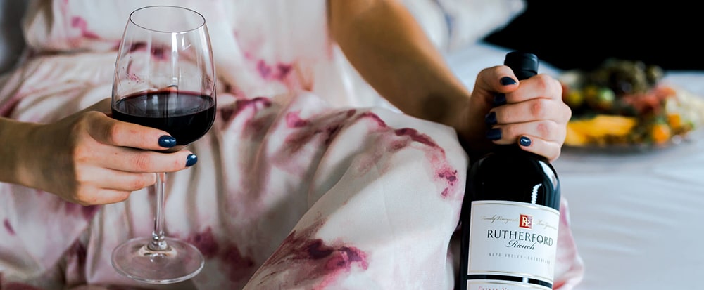 Woman holding wine bottle and glass